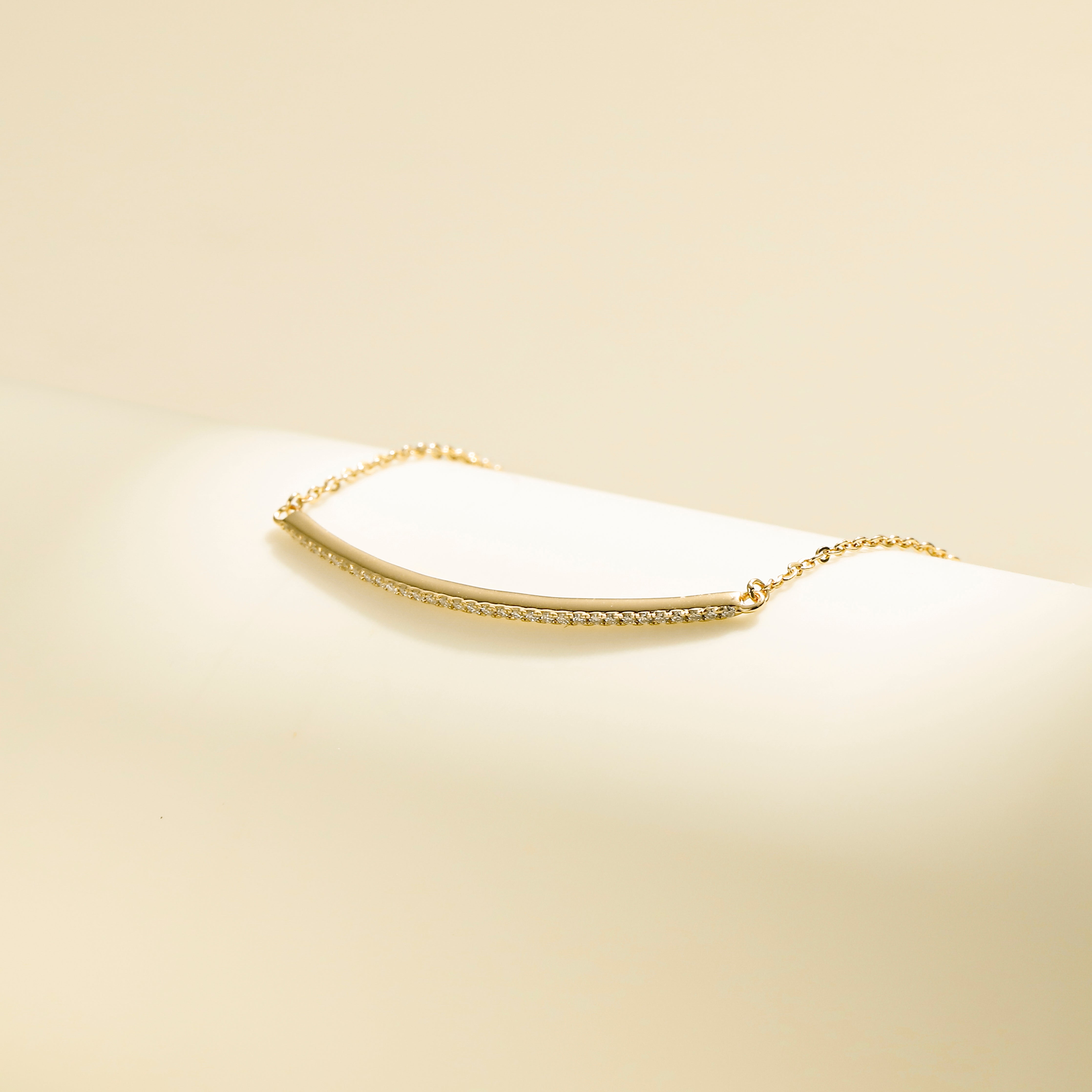 Minimalist Arc Charm Bracelet in 18 carat gold vermeil, adorned with a Moissanite arc design and an adjustable chain, perfect for daily wear or as a thoughtful gift.