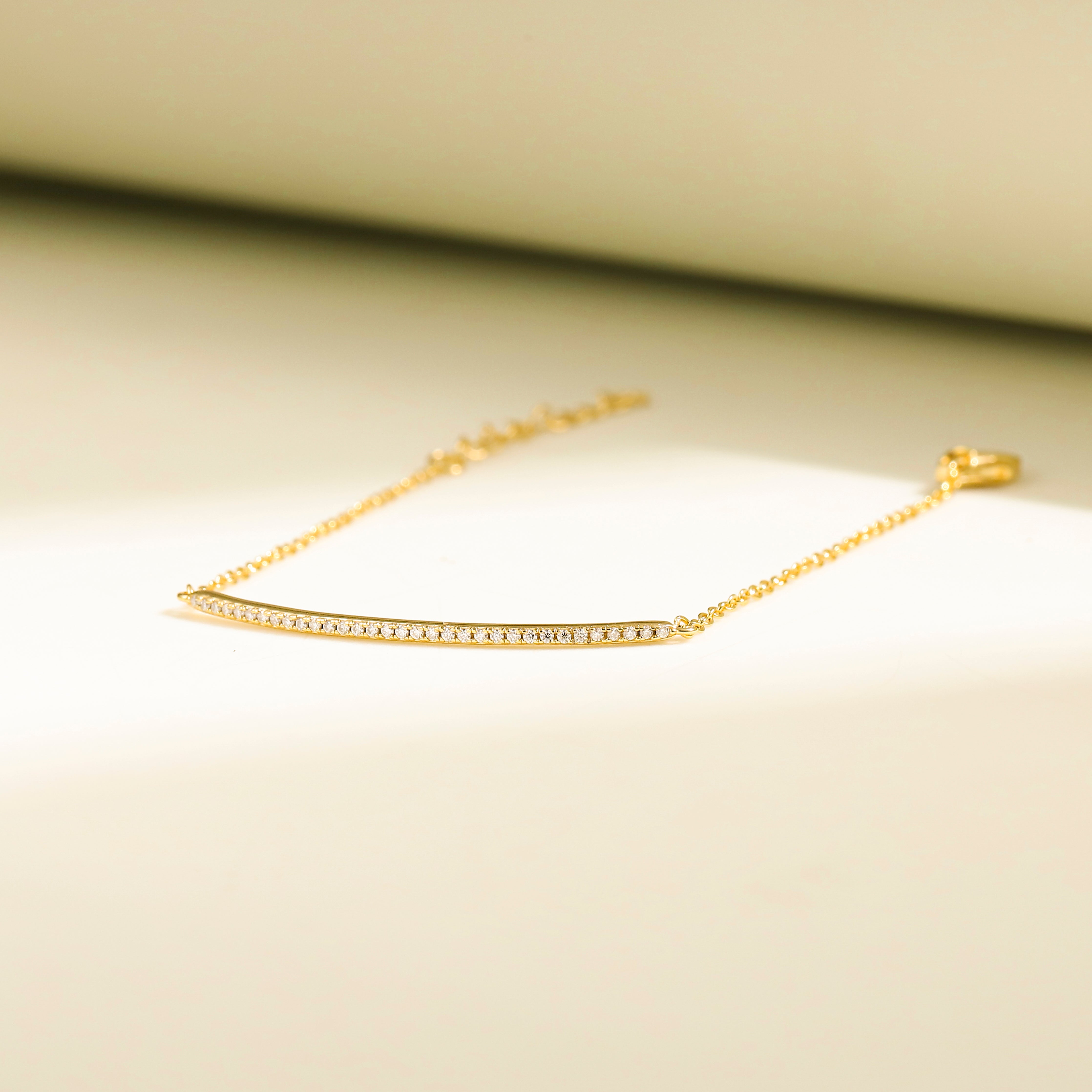 Minimalist Arc Charm Bracelet in 18 carat gold vermeil, adorned with a Moissanite arc design and an adjustable chain, perfect for daily wear or as a thoughtful gift.