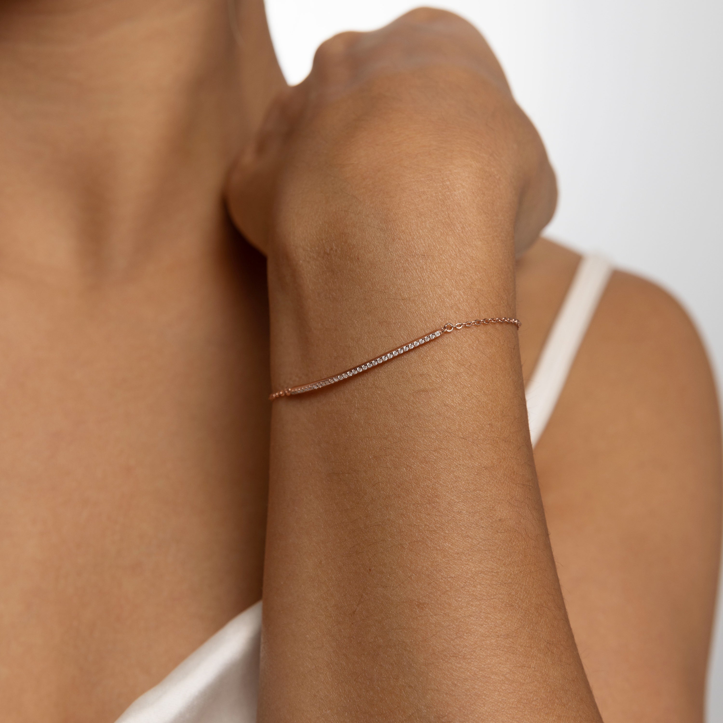 Minimalist Arc Charm Bracelet in 18 carat rose gold vermeil, adorned with a Moissanite arc design and an adjustable chain, perfect for daily wear or as a thoughtful gift.