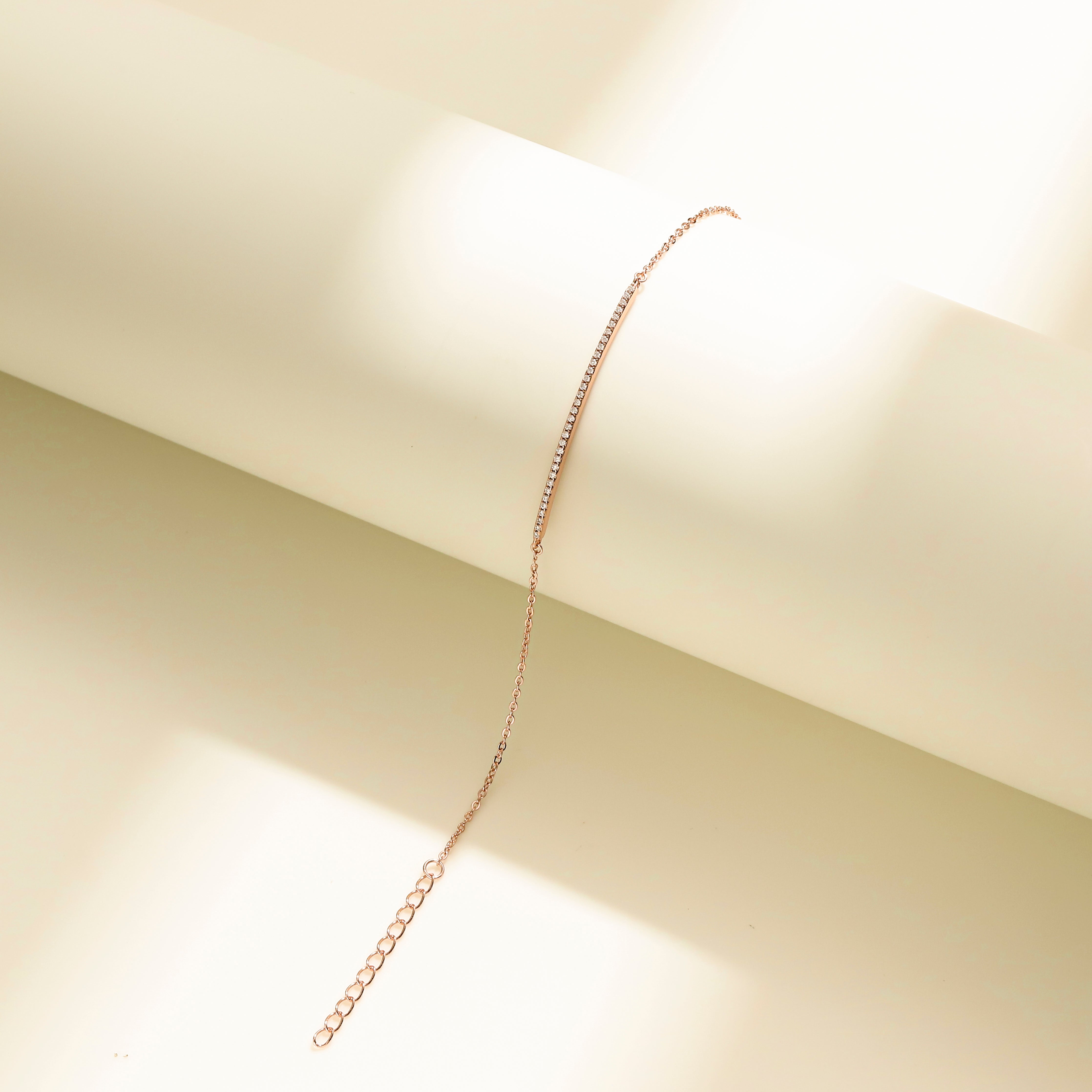 Minimalist Arc Charm Bracelet in 18 carat rose gold vermeil, adorned with a Moissanite arc design and an adjustable chain, perfect for daily wear or as a thoughtful gift.