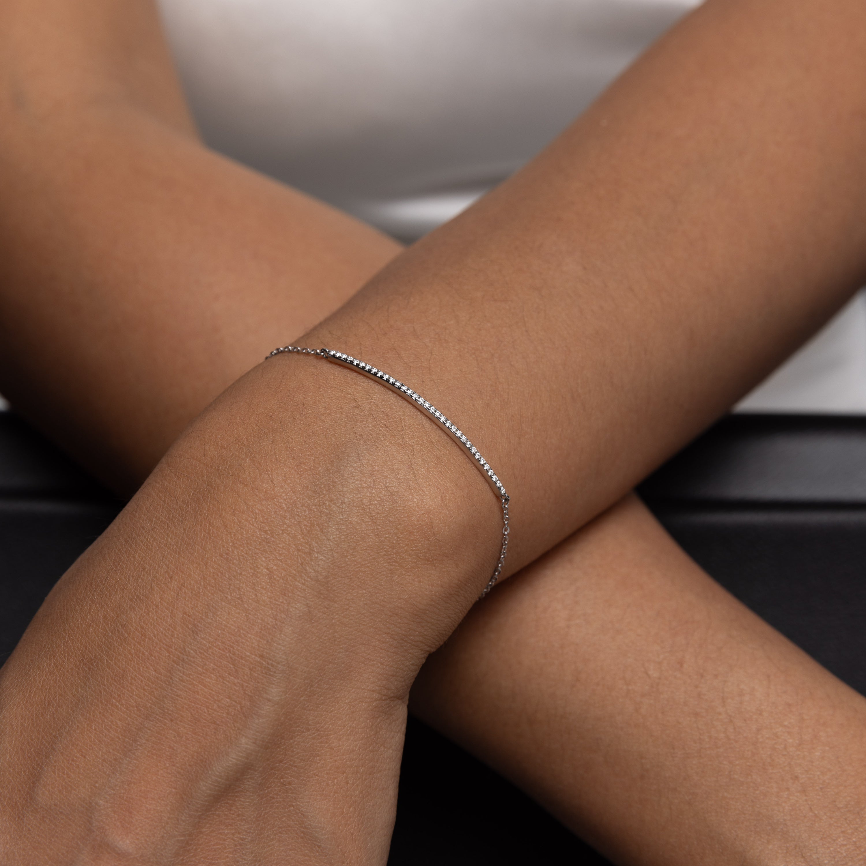 Minimalist Arc Charm Bracelet in 18 carat white gold vermeil, adorned with a Moissanite arc design and an adjustable chain, perfect for daily wear or as a thoughtful gift.