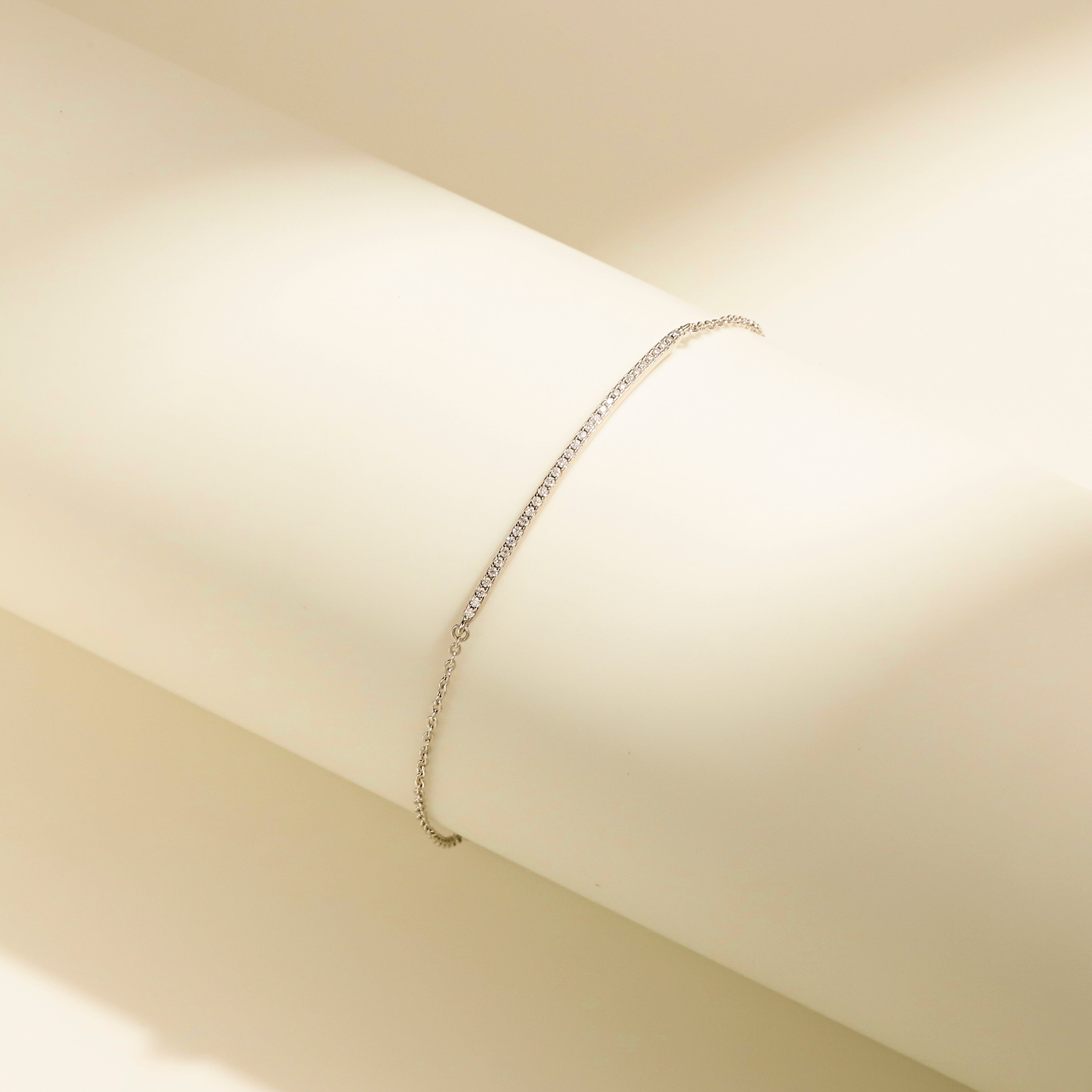 Minimalist Arc Charm Bracelet in 18 carat white gold vermeil, adorned with a Moissanite arc design and an adjustable chain, perfect for daily wear or as a thoughtful gift.