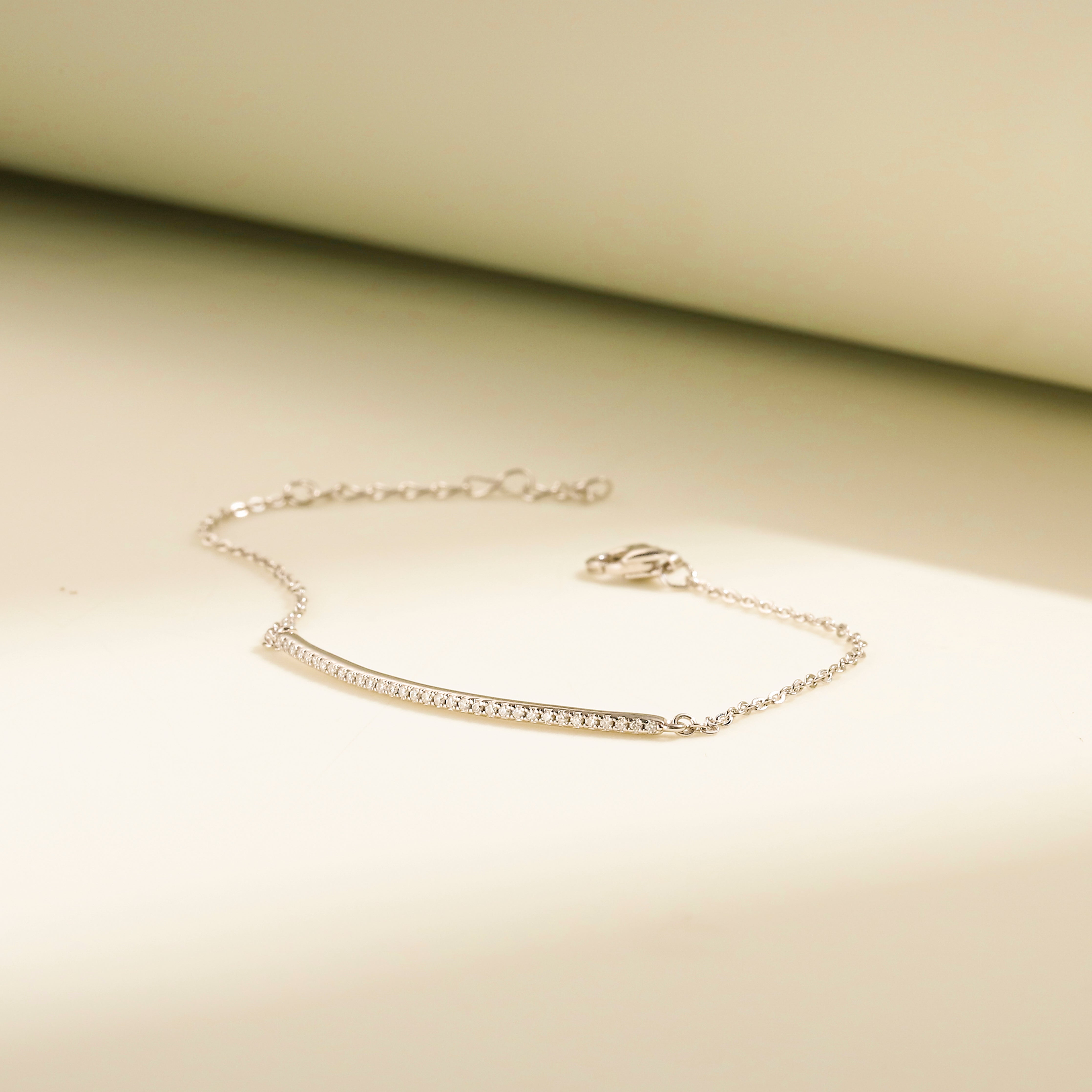 Minimalist Arc Charm Bracelet in 18 carat white gold vermeil, adorned with a Moissanite arc design and an adjustable chain, perfect for daily wear or as a thoughtful gift.