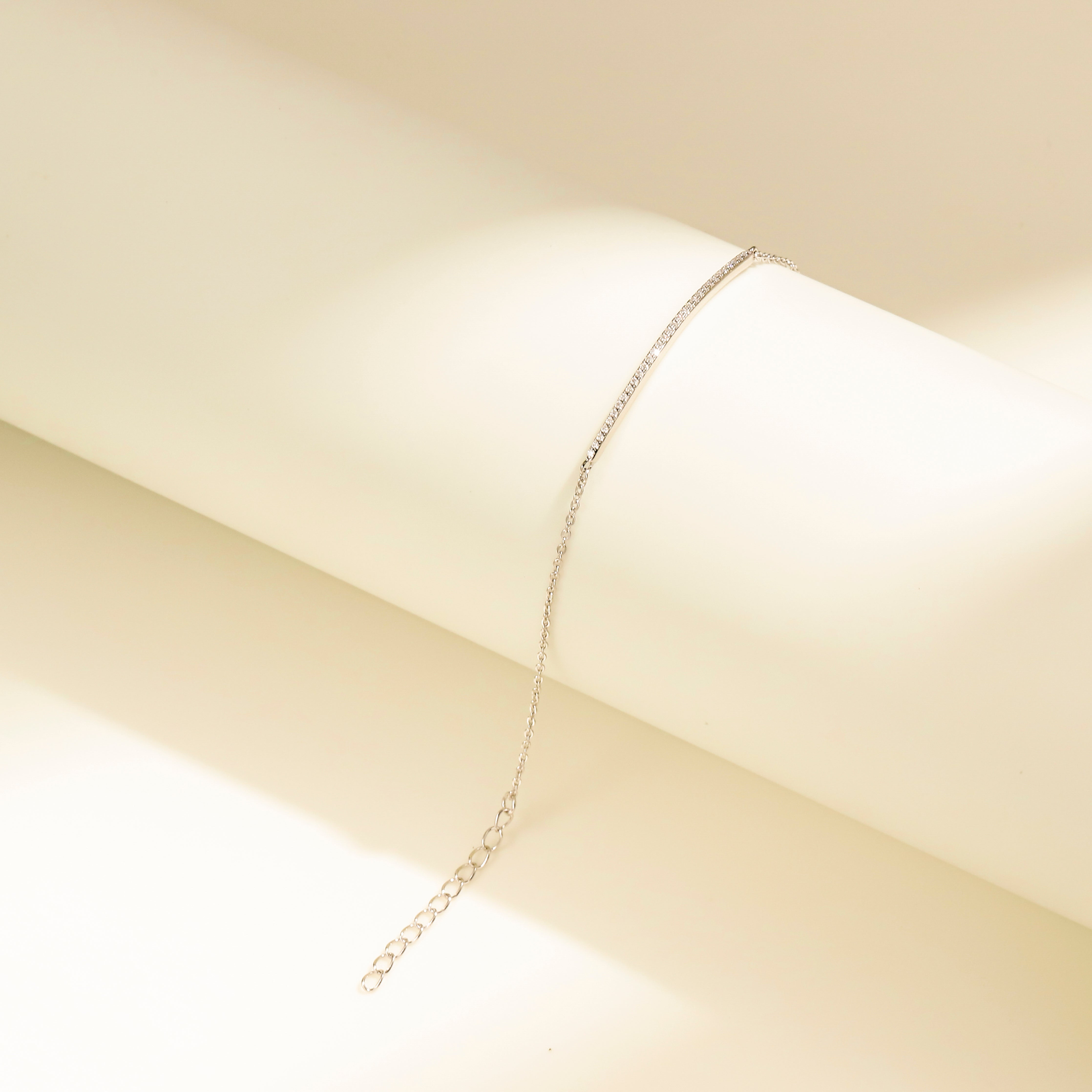 Minimalist Arc Charm Bracelet in 18 carat white gold vermeil, adorned with a Moissanite arc design and an adjustable chain, perfect for daily wear or as a thoughtful gift.