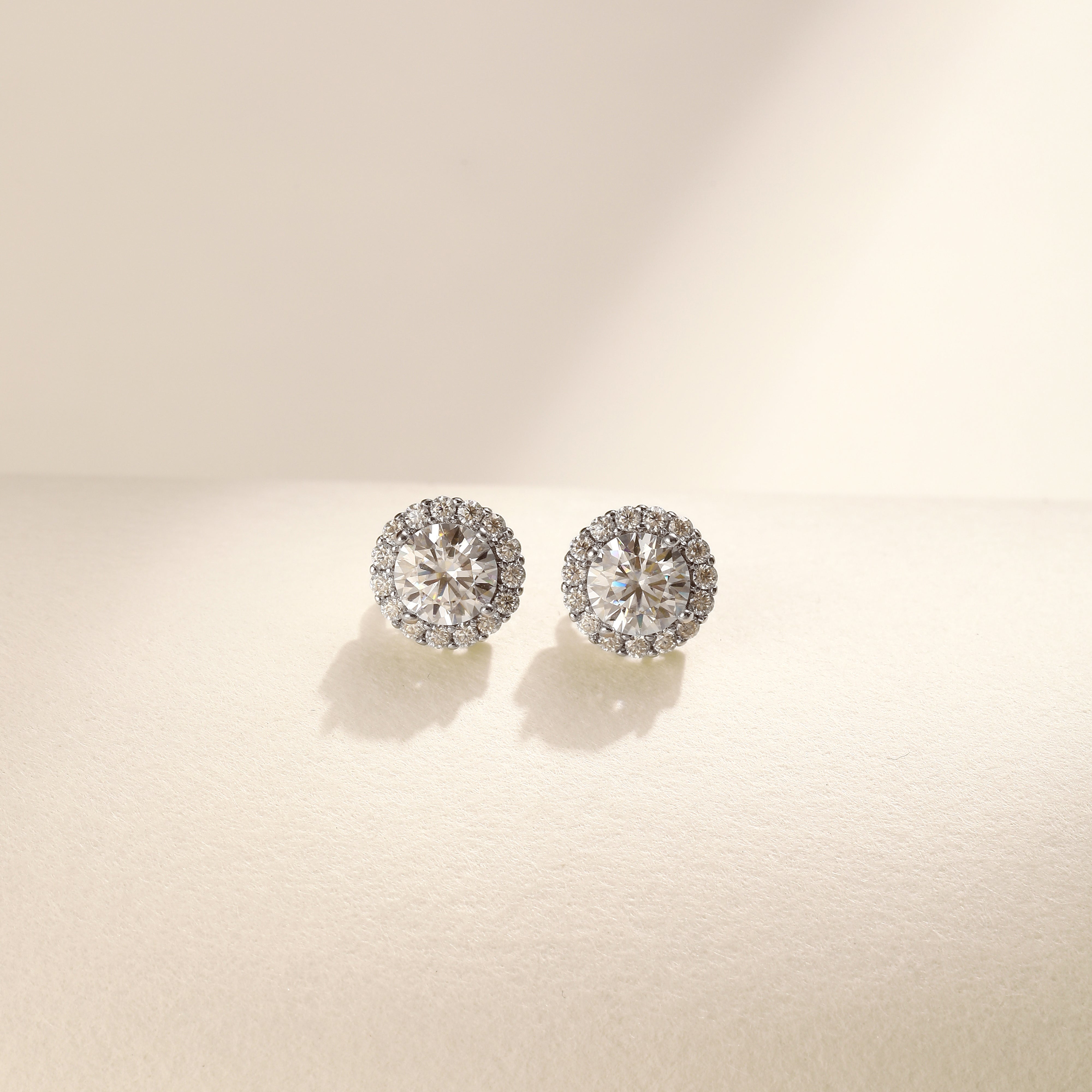 Brilliance Halo Studs in 18 carat white gold vermeil, featuring a brilliant Moissanite center stone surrounded by a halo of smaller stones, perfect for daily wear or as a thoughtful gift.