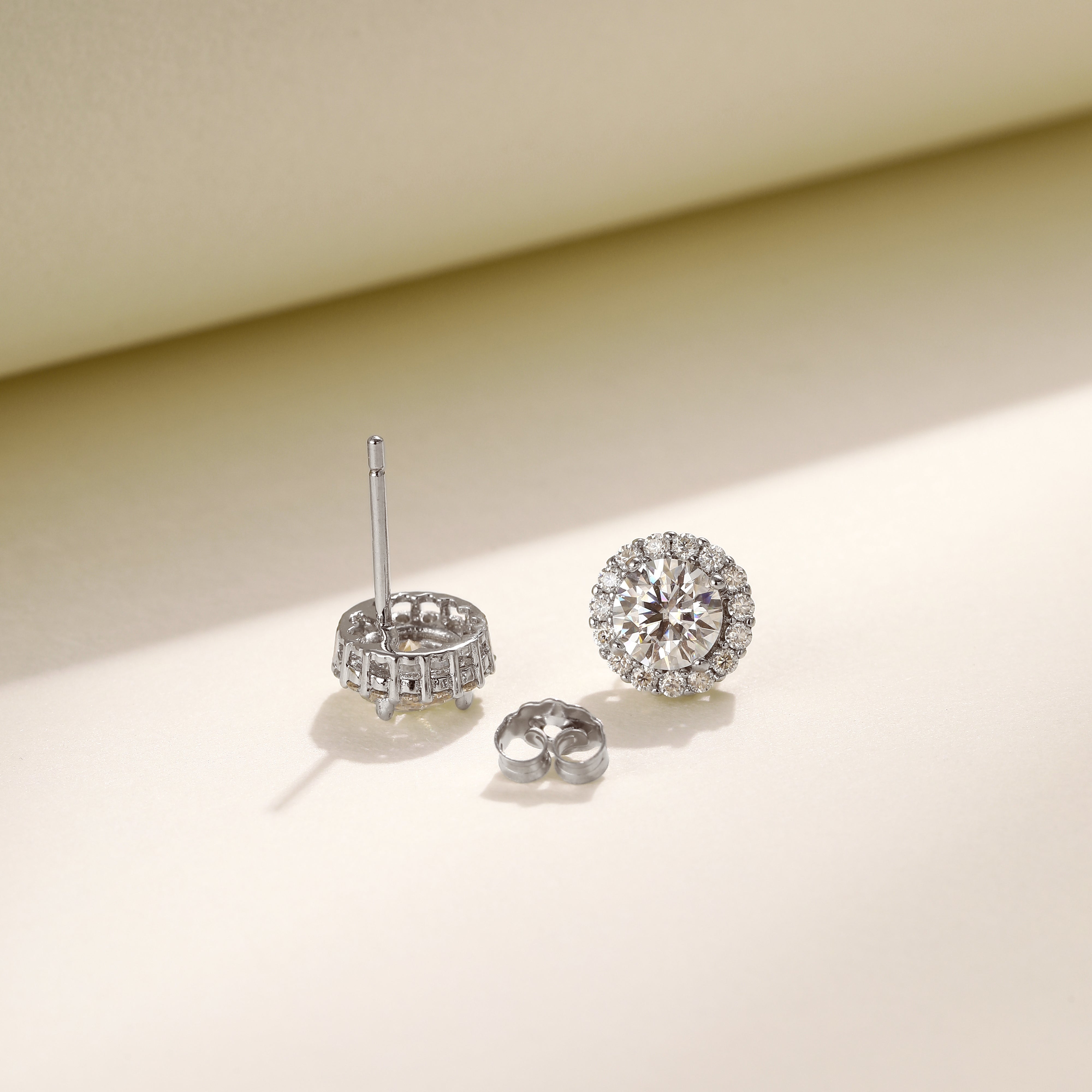 Brilliance Halo Studs in 18 carat white gold vermeil, featuring a brilliant Moissanite center stone surrounded by a halo of smaller stones, perfect for daily wear or as a thoughtful gift.