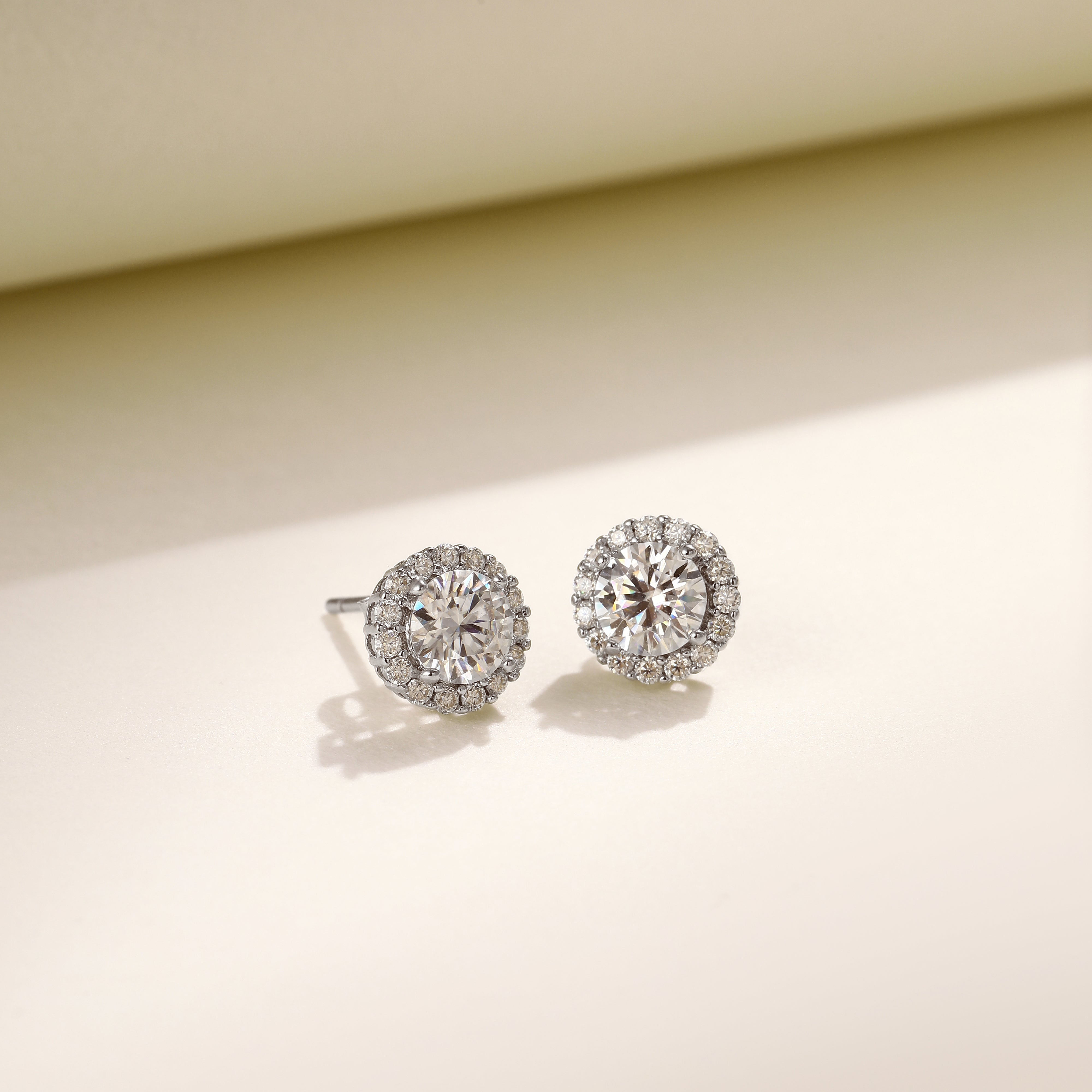 Brilliance Halo Studs in 18 carat white gold vermeil, featuring a brilliant Moissanite center stone surrounded by a halo of smaller stones, perfect for daily wear or as a thoughtful gift.