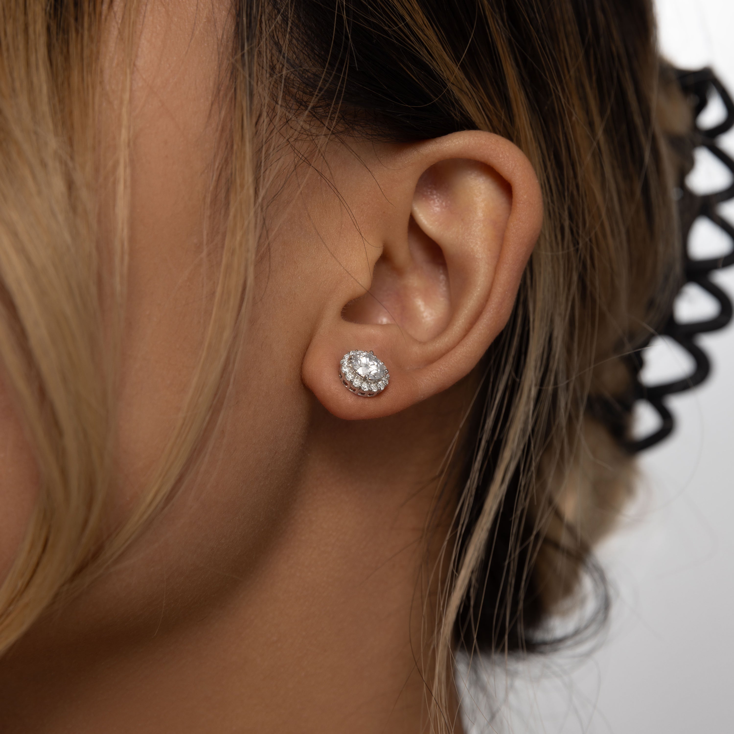 Brilliance Halo Studs in 18 carat white gold vermeil, featuring a brilliant Moissanite center stone surrounded by a halo of smaller stones, perfect for daily wear or as a thoughtful gift.