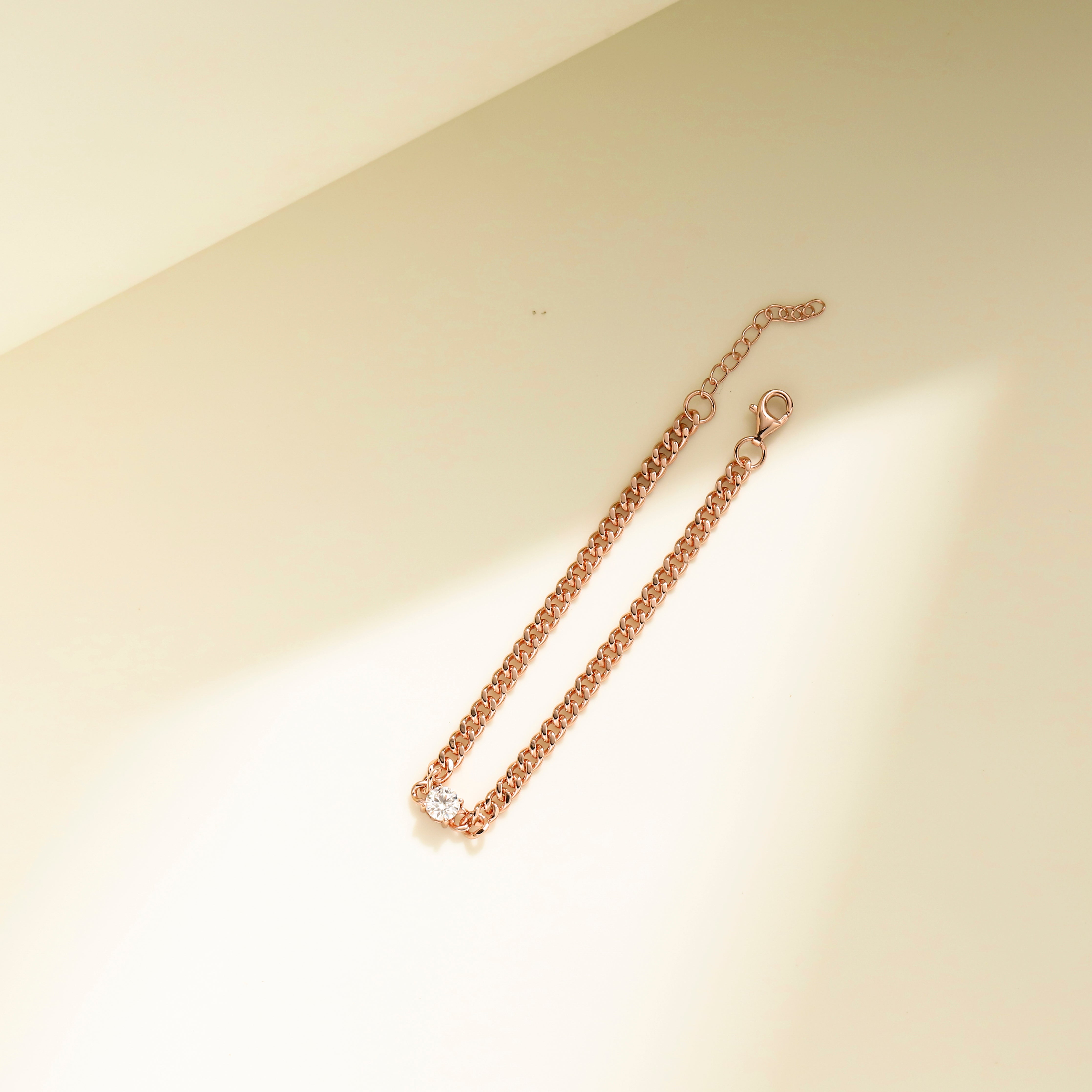 Minimalist chain bracelet in 18 carat rose gold vermeil featuring a single Moissanite stone with adjustable chain, perfect for daily wear or as a thoughtful gift.