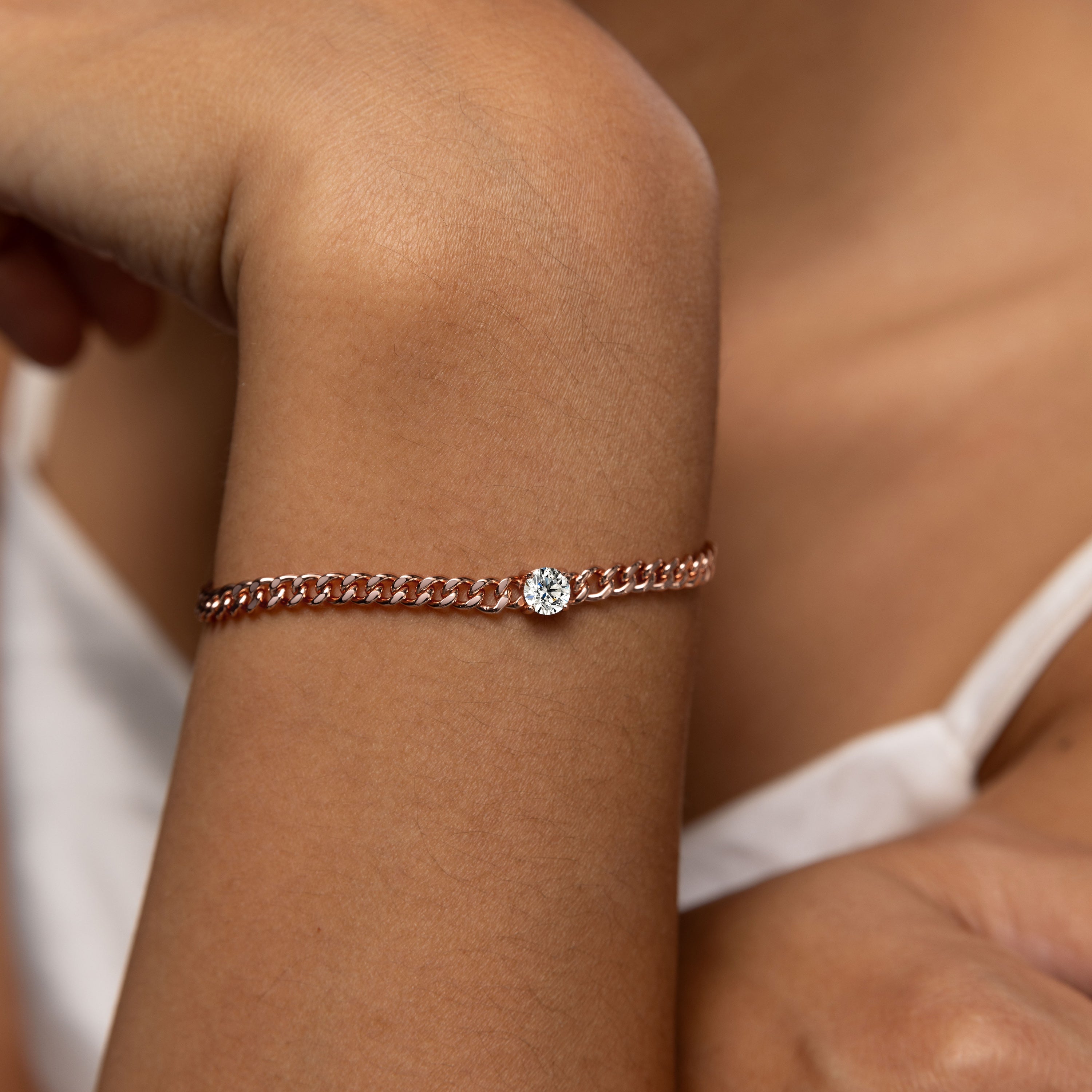 Minimalist chain bracelet in 18 carat rose gold vermeil featuring a single Moissanite stone with adjustable chain, perfect for daily wear or as a thoughtful gift.