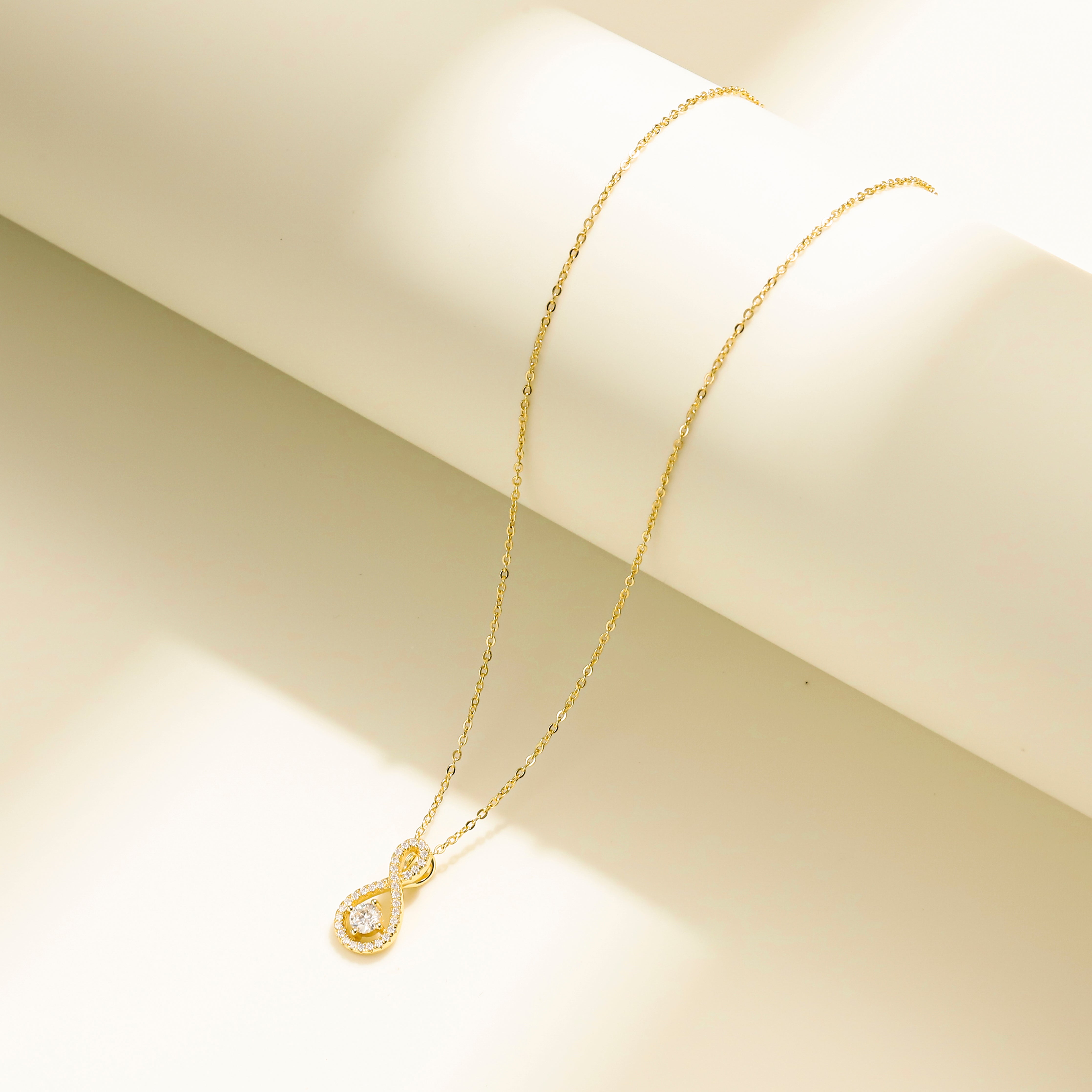 Eternal Loop Necklace in 18 carat gold vermeil featuring an infinity loop design with a center Moissanite stone and adjustable chain, perfect for daily wear or as a thoughtful gift.