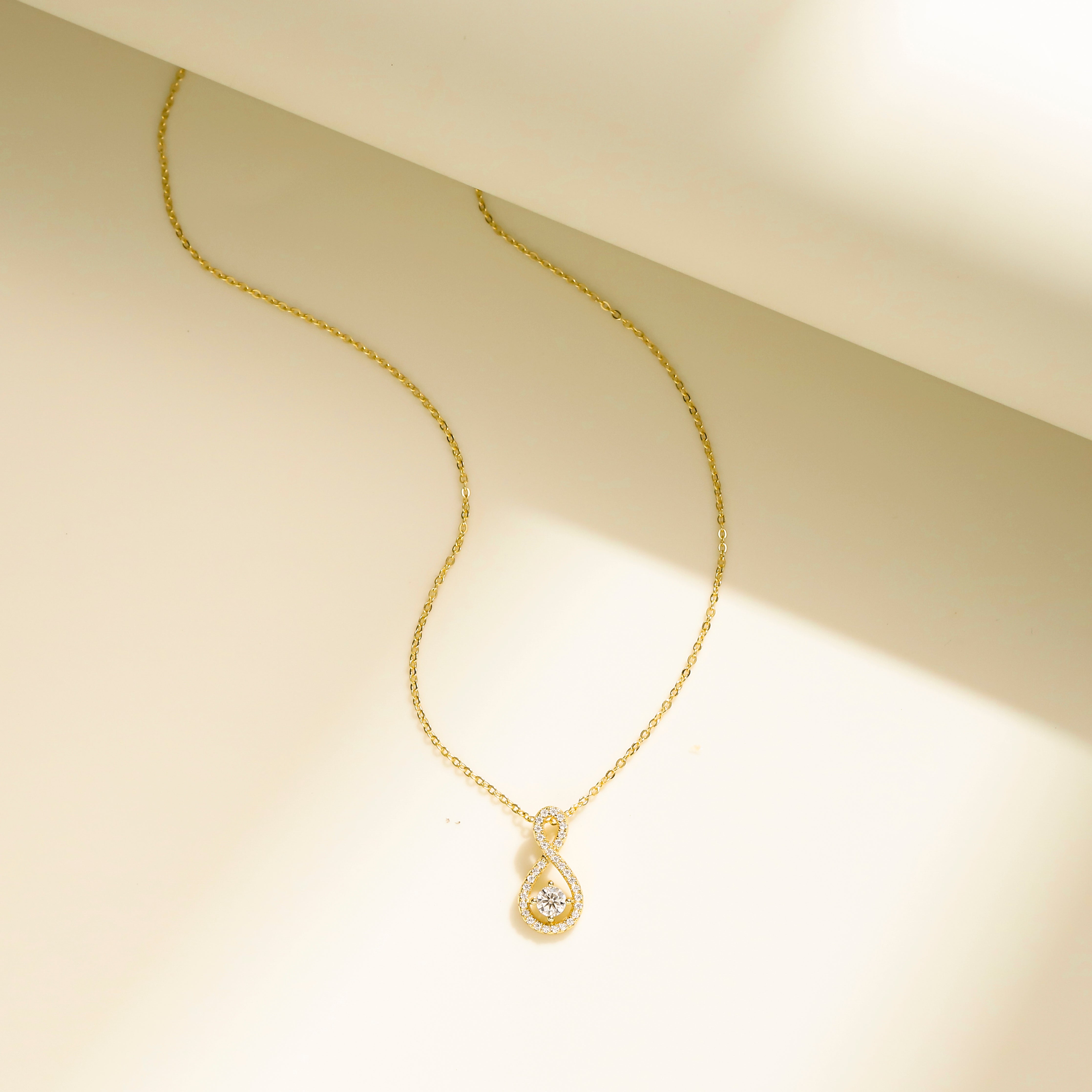 Eternal Loop Necklace in 18 carat gold vermeil featuring an infinity loop design with a center Moissanite stone and adjustable chain, perfect for daily wear or as a thoughtful gift.