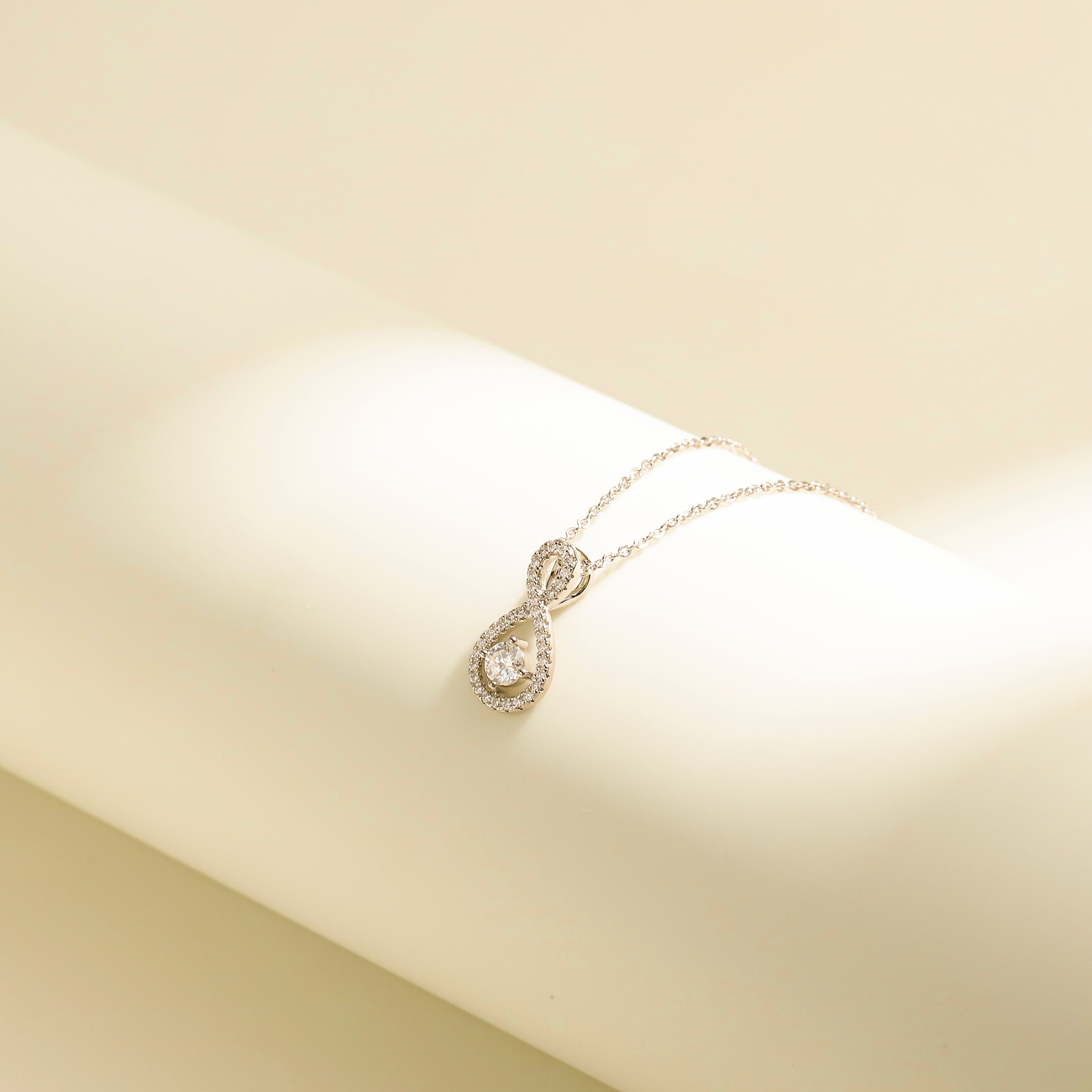 Eternal Loop Necklace in 18 carat white gold vermeil featuring an infinity loop design with a center Moissanite stone and adjustable chain, perfect for daily wear or as a thoughtful gift.