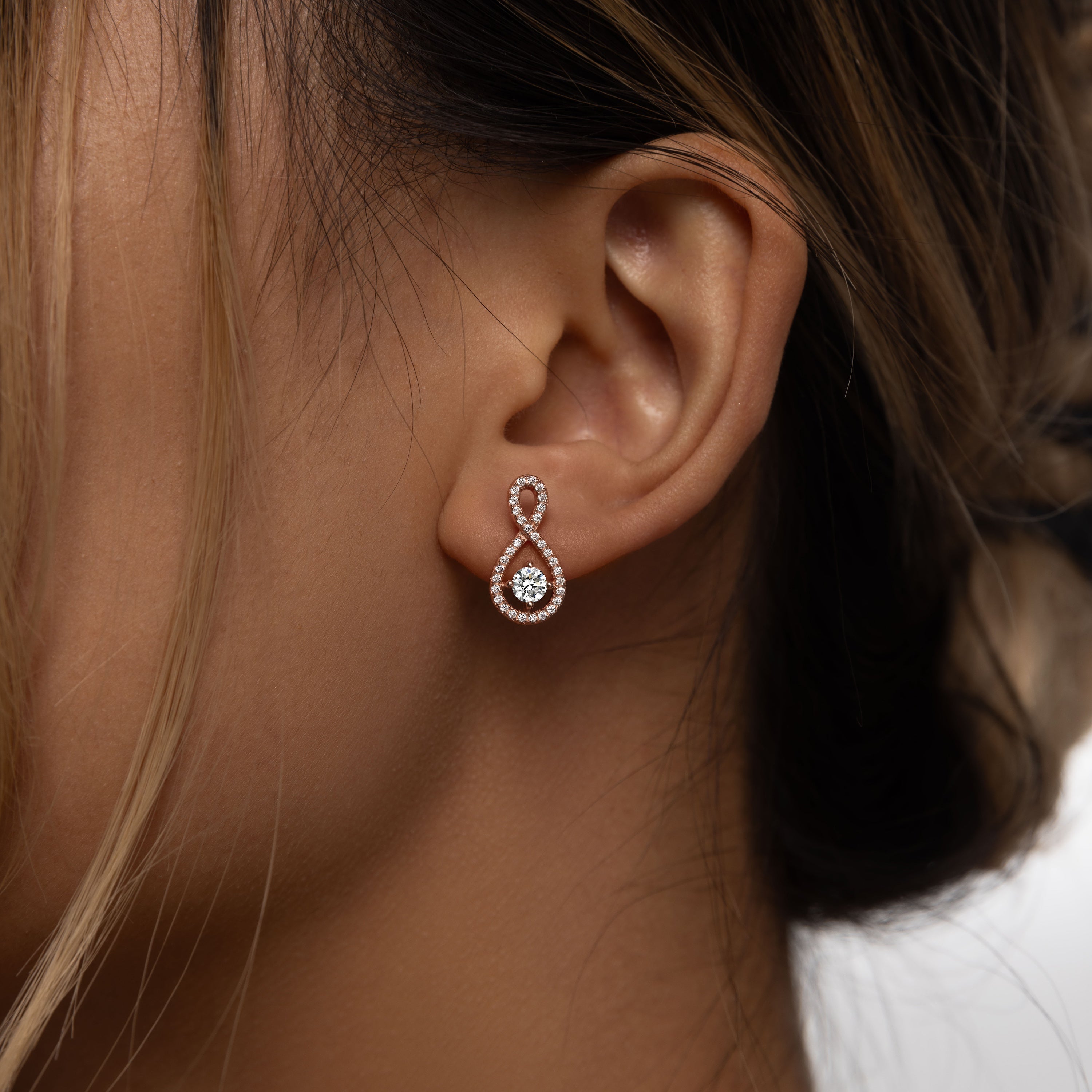 Elegant Loop Earring Studs in 18 carat rose gold vermeil, featuring an infinity loop design with a central Moissanite stone, perfect for daily wear or as a thoughtful gift.