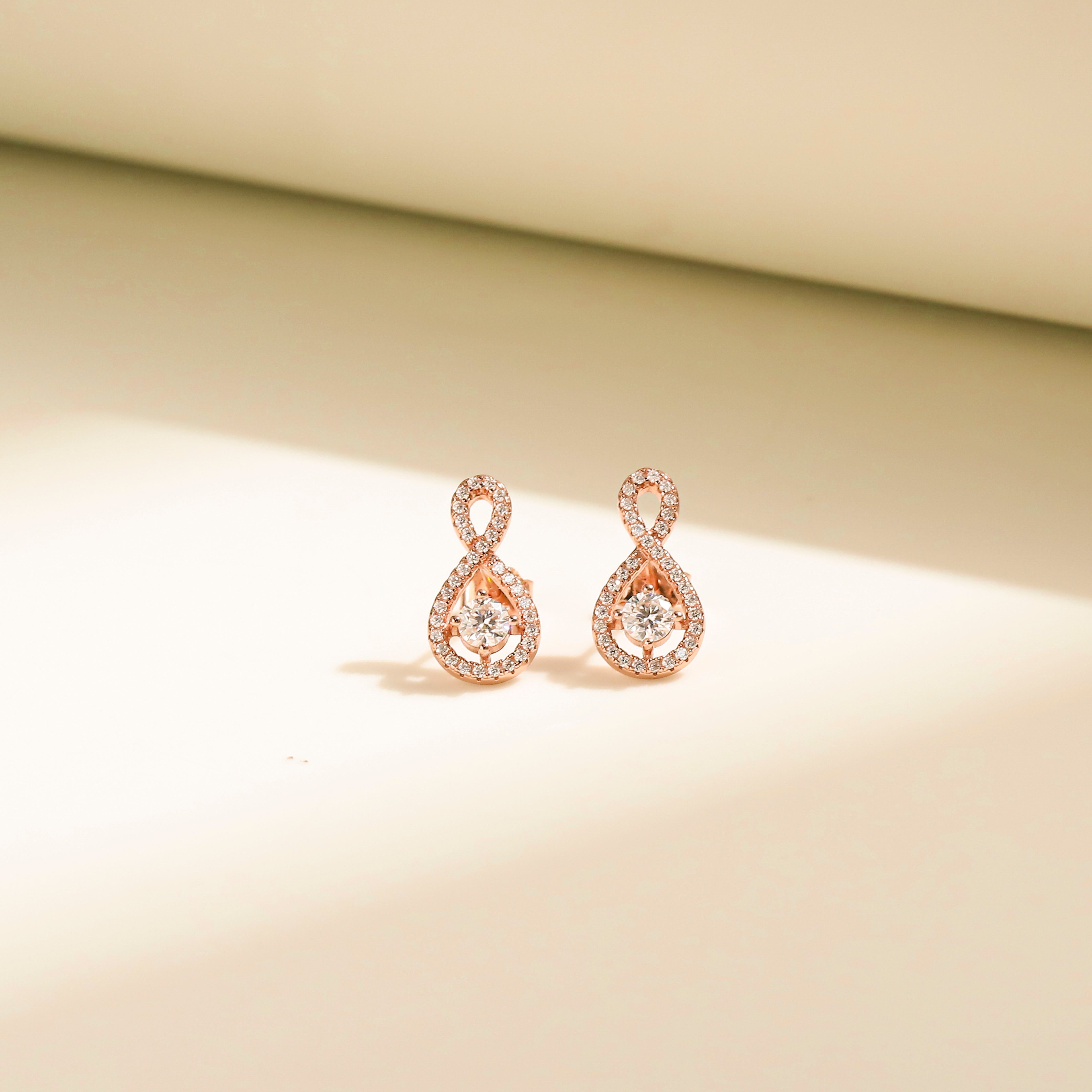 Elegant Loop Earring Studs in 18 carat rose gold vermeil, featuring an infinity loop design with a central Moissanite stone, perfect for daily wear or as a thoughtful gift.