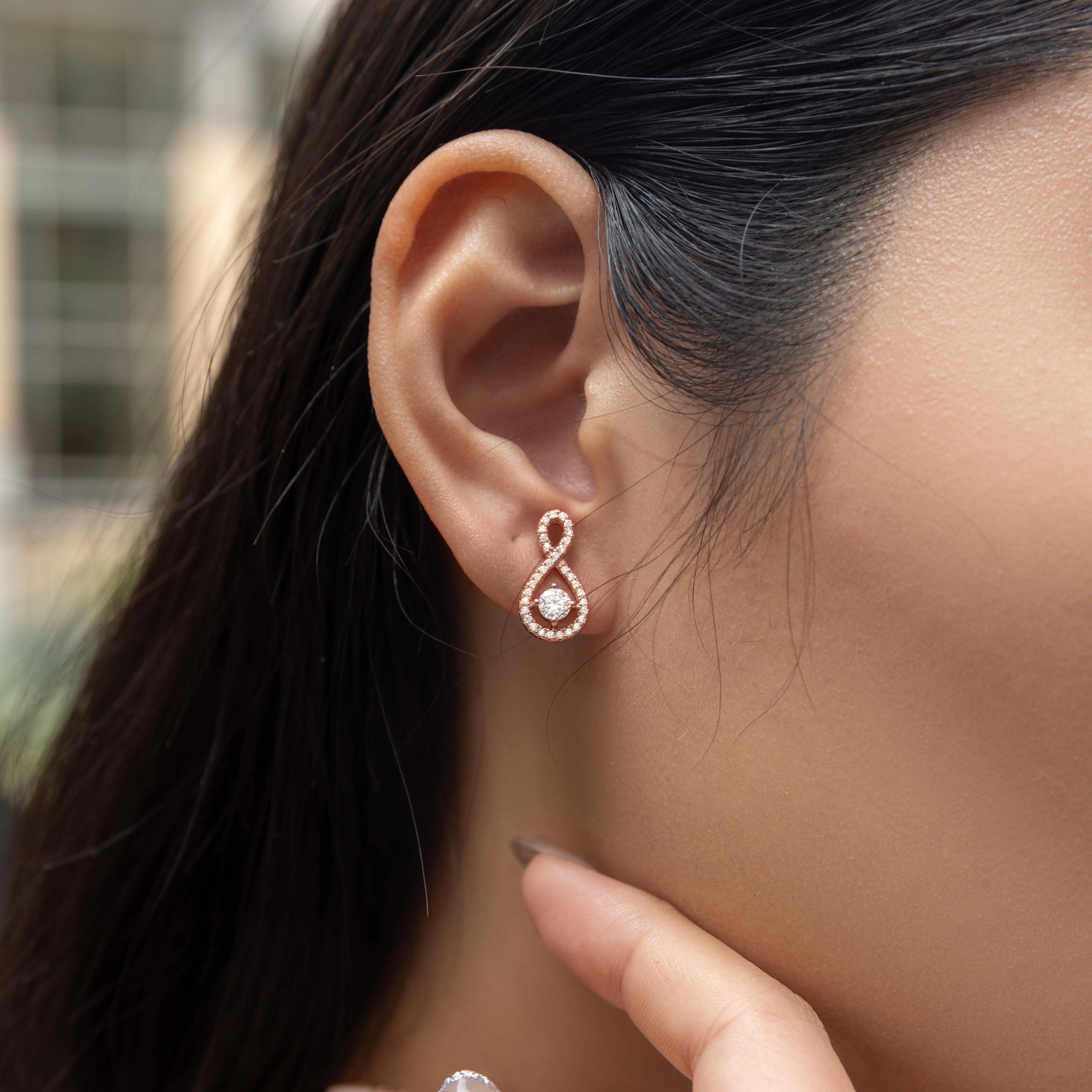 Elegant Loop Earring Studs in 18 carat rose gold vermeil, featuring an infinity loop design with a central Moissanite stone, perfect for daily wear or as a thoughtful gift.