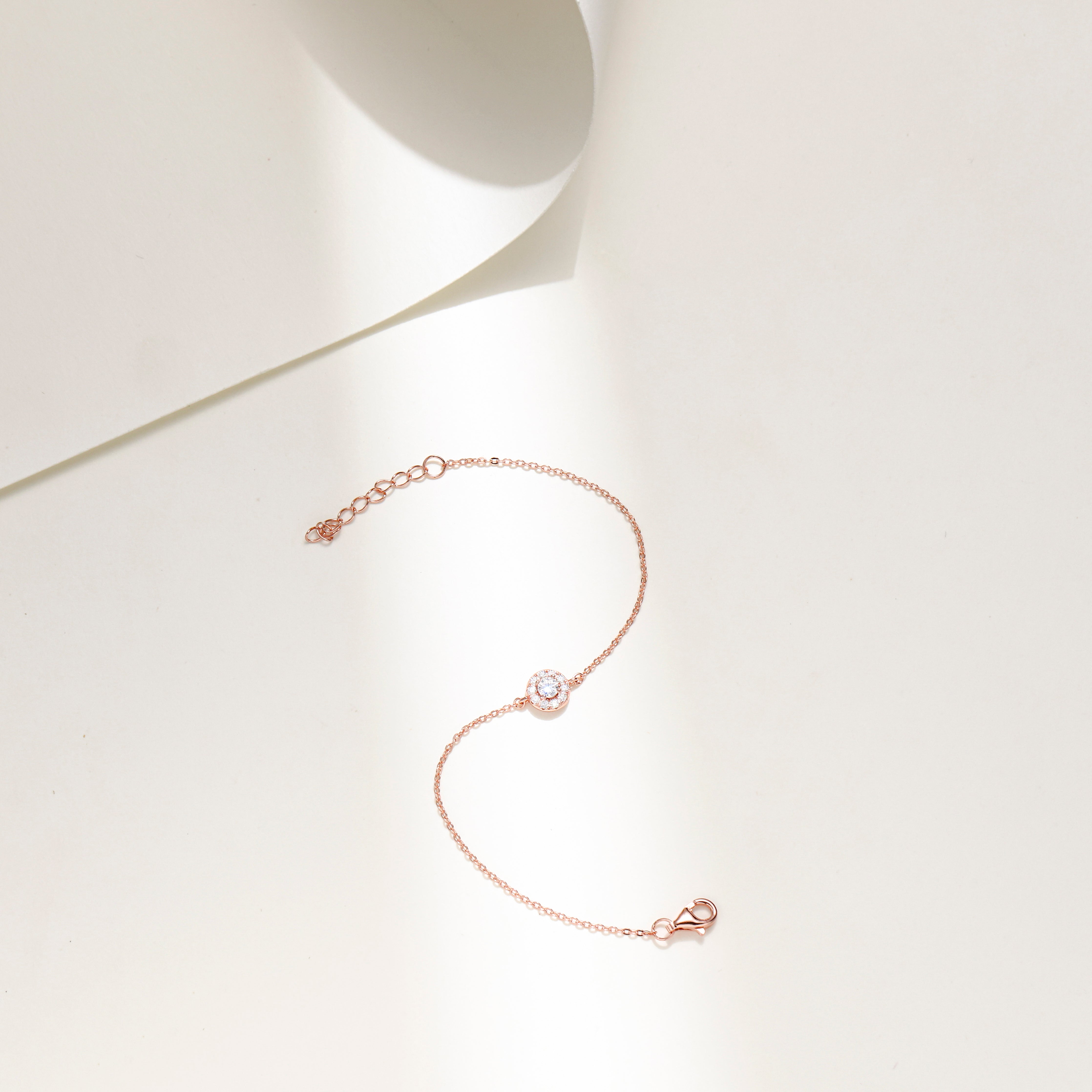 Minimalist Halo Charm Bracelet in 18 carat rose gold vermeil featuring a central Moissanite stone surrounded by a halo design, set on an adjustable chain, perfect for daily wear or as a thoughtful gift.