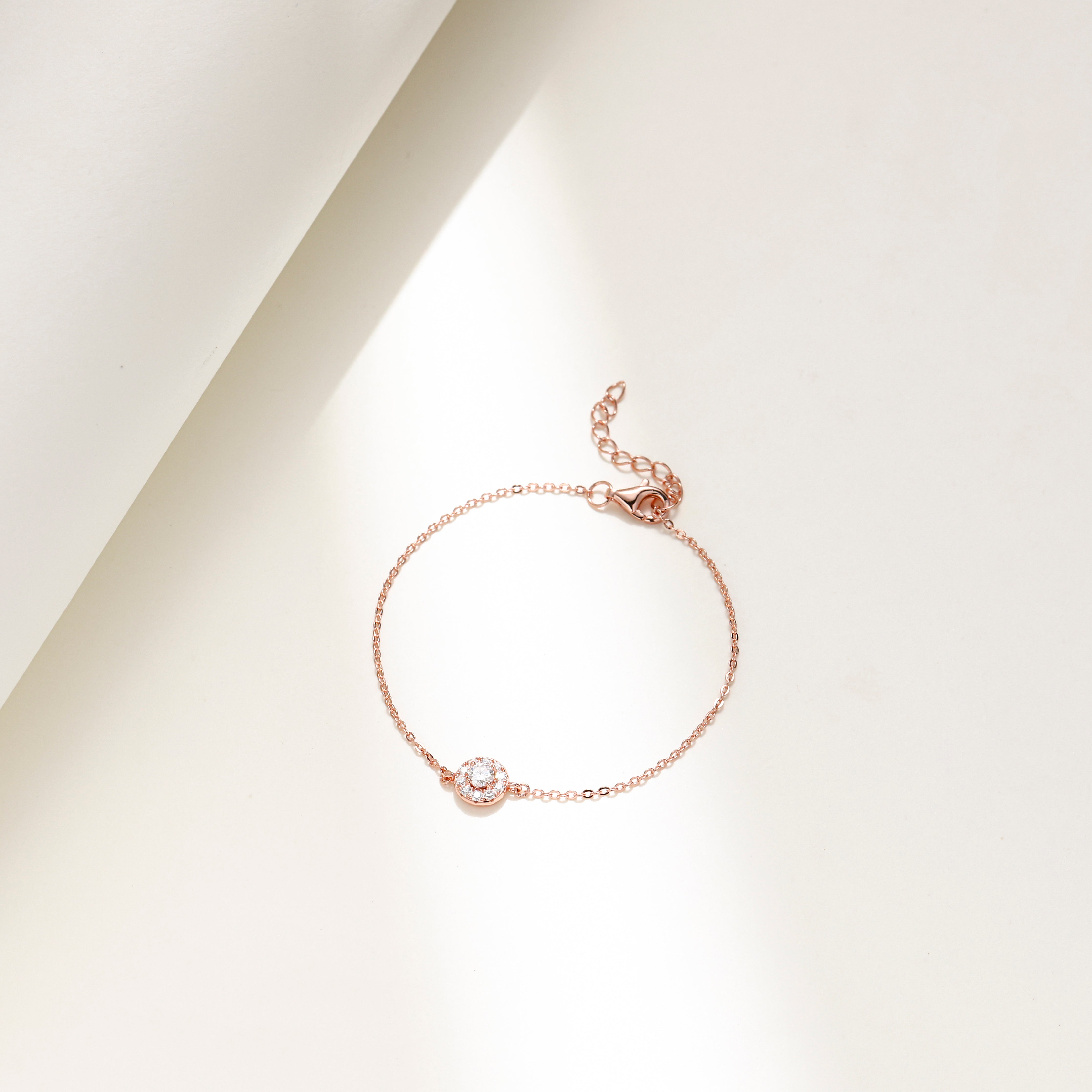Minimalist Halo Charm Bracelet in 18 carat rose gold vermeil featuring a central Moissanite stone surrounded by a halo design, set on an adjustable chain, perfect for daily wear or as a thoughtful gift.