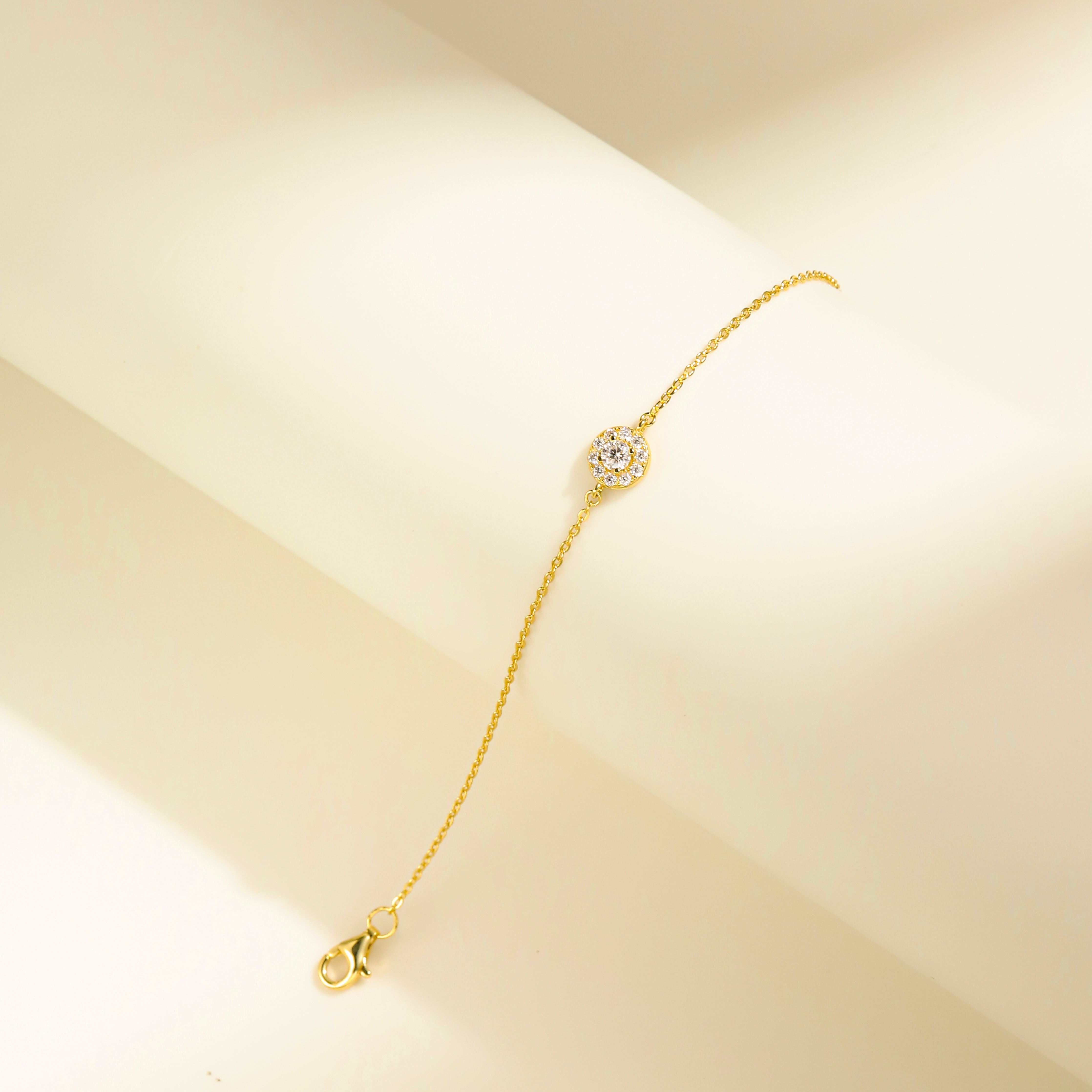 Minimalist Halo Charm Bracelet in 18 carat gold vermeil featuring a central Moissanite stone surrounded by a halo design, set on an adjustable chain, perfect for daily wear or as a thoughtful gift.