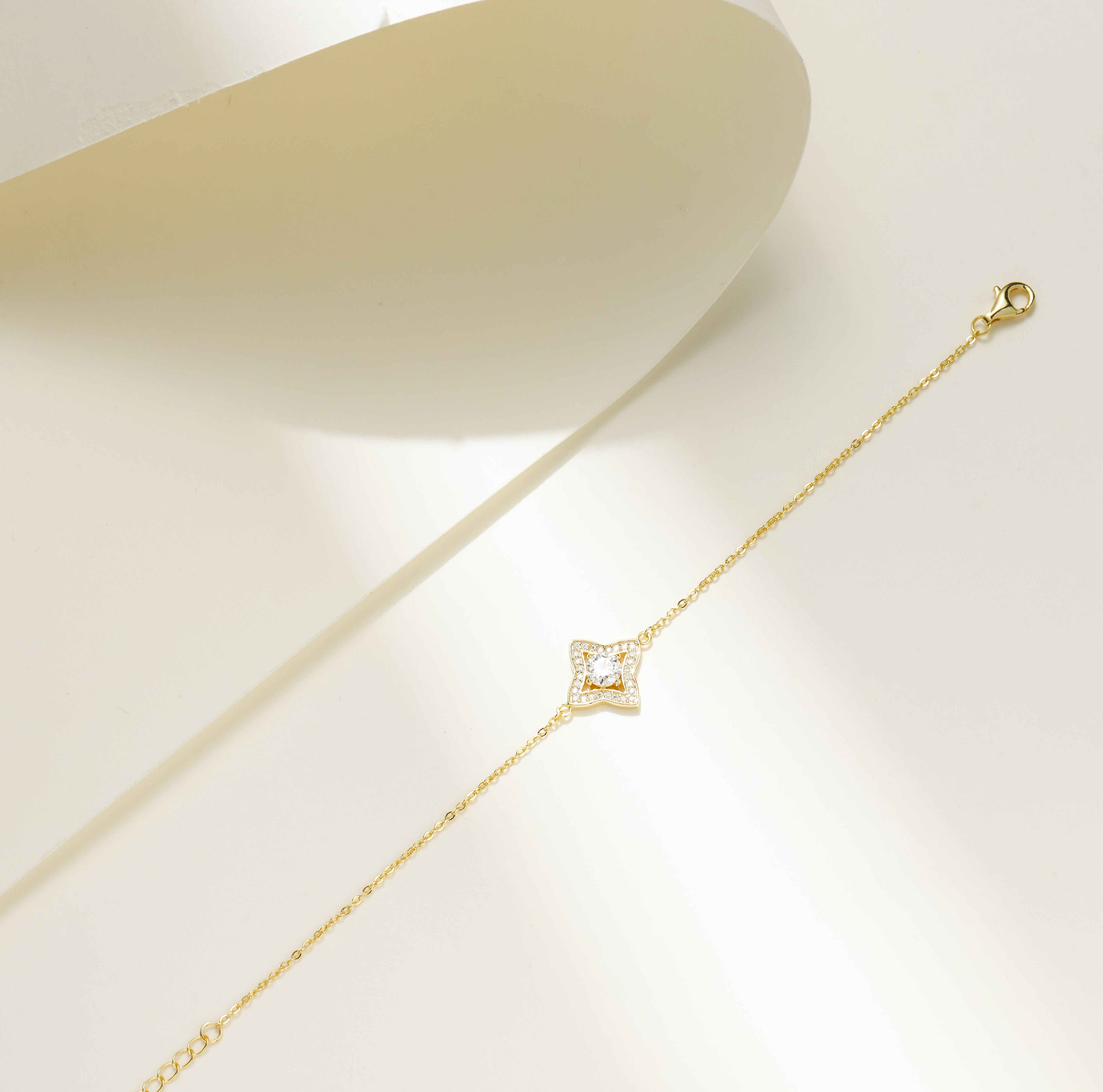 Gold-plated Luxe Star Bracelet featuring a star-shaped charm adorned with sparkling Moissanite stones, displayed on a delicate adjustable chain.