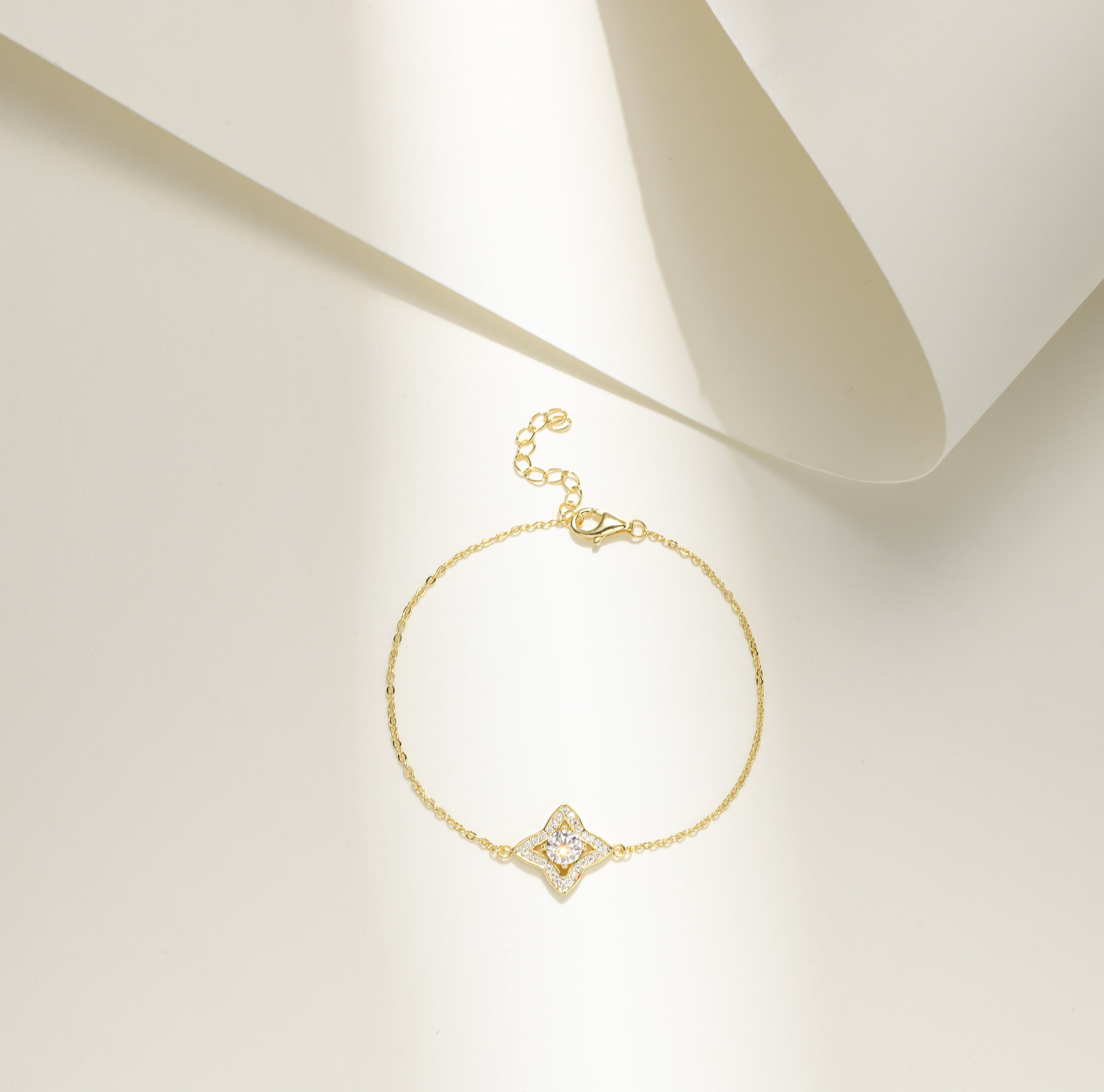 Gold-plated Luxe Star Bracelet featuring a star-shaped charm adorned with sparkling Moissanite stones, displayed on a delicate adjustable chain.