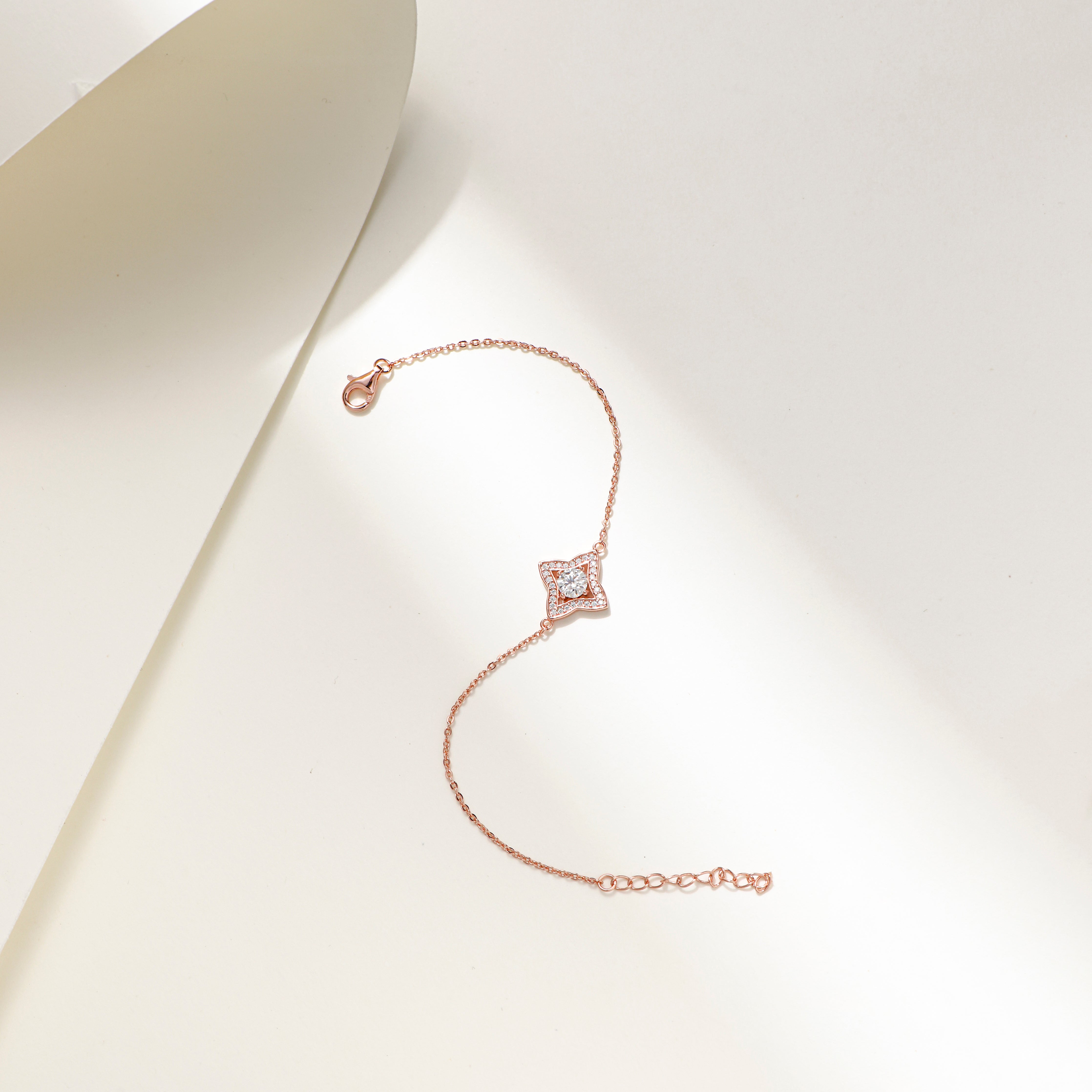 Rose gold-plated Luxe Star Bracelet with a star-shaped charm adorned with sparkling Moissanite stones, displayed on a delicate adjustable chain.