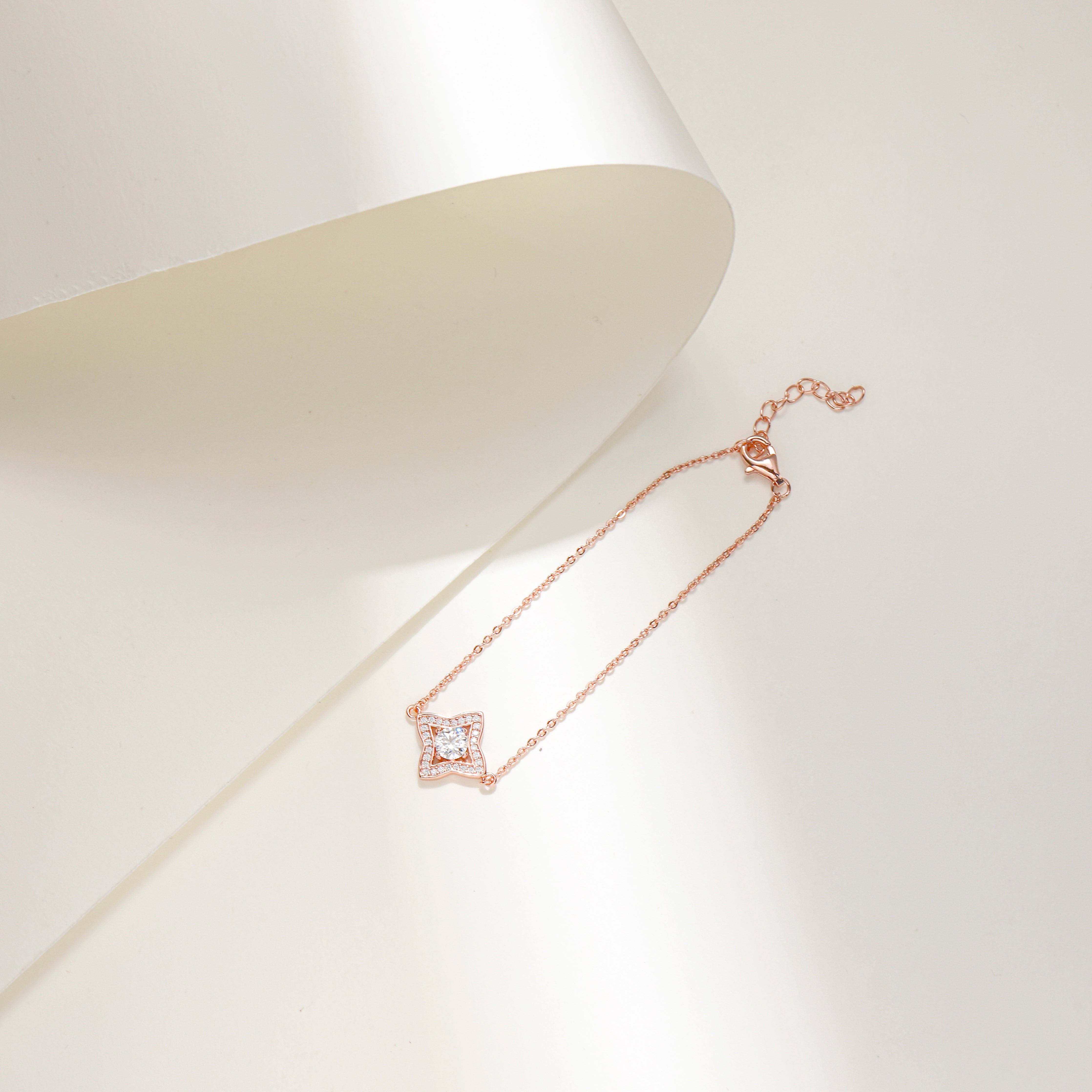 Rose gold-plated Luxe Star Bracelet with a star-shaped charm adorned with sparkling Moissanite stones, displayed on a delicate adjustable chain.