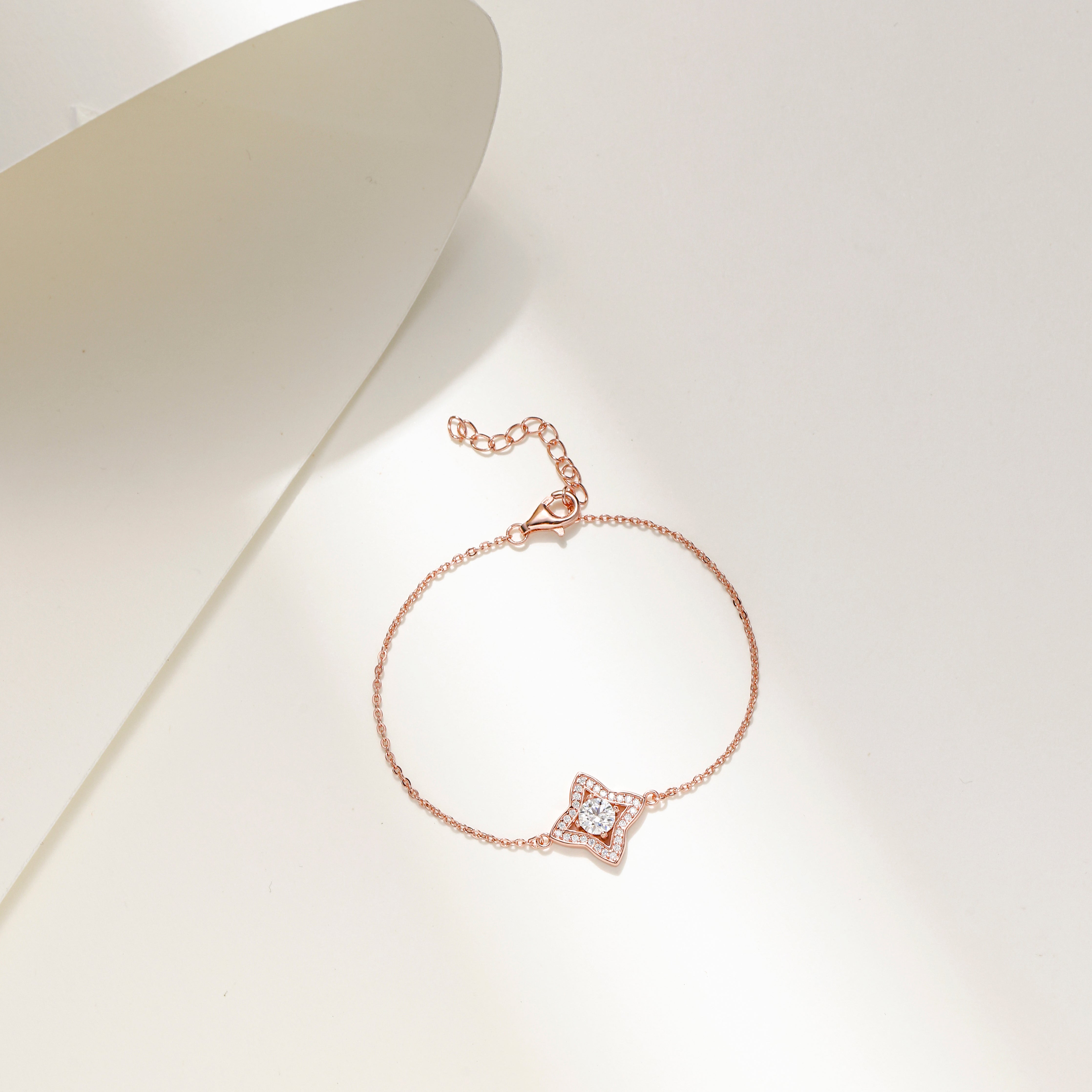 Rose gold-plated Luxe Star Bracelet with a star-shaped charm adorned with sparkling Moissanite stones, displayed on a delicate adjustable chain.